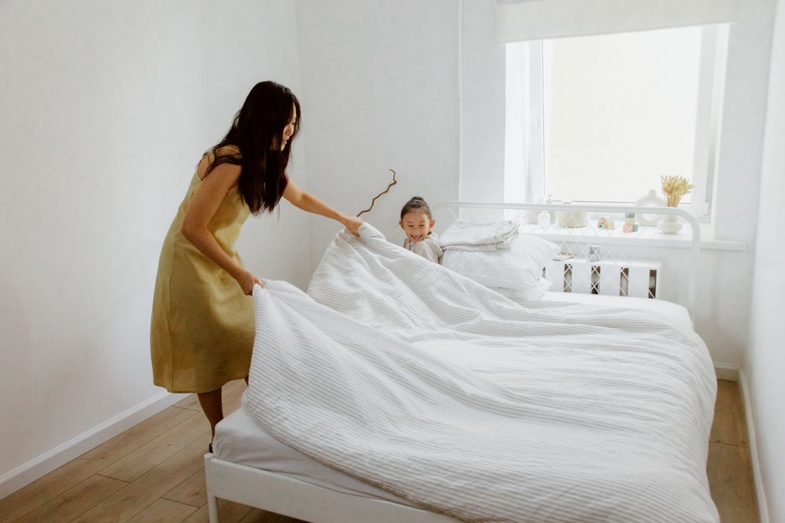 Fresh linen folded on a made bed
