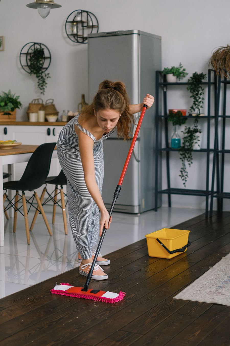 Mopping the floor in a bright open-plan kitchen