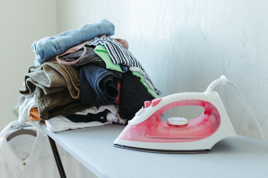 A shirt being pressed on an ironing board