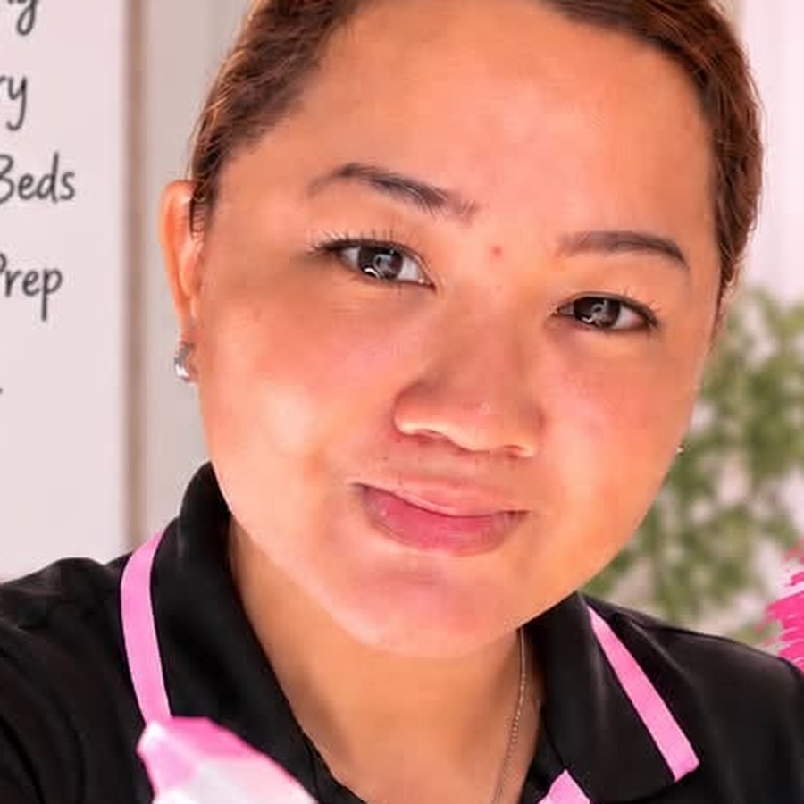 A Wifey in the branded polo with a spray bottle, ready to start